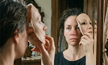 image of a woman taking off her mask